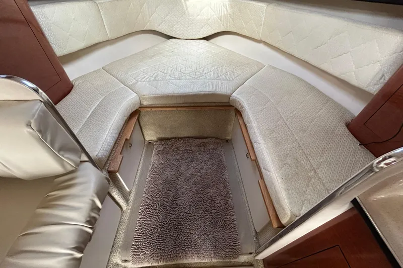 Slide: The Image of Interior cabin of 2004 Sea Ray 280 Sundancer with cushioned seating and carpeted floor. - 28