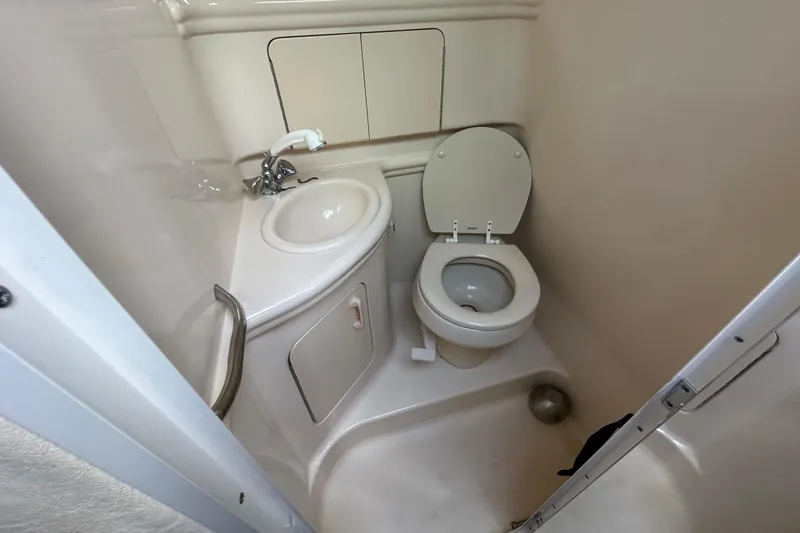 Slide: The Image of 2004 Sea Ray 280 Sundancer bathroom with sink and toilet. - 32