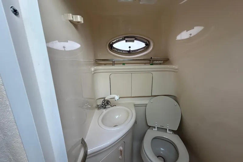 Slide: The Image of Compact bathroom in 2004 Sea Ray 280 Sundancer boat with sink and toilet. - 33