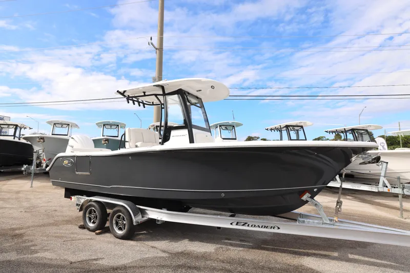 Slide: The Image of 2026 Sea Hunt Ultra 245 SE boat on trailer under blue sky. - 6