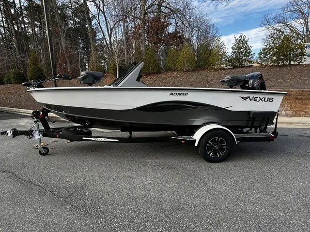 The Image of 2024 Vexus ADX180 boat on trailer, parked outdoors, showcasing sleek design and modern features. - 1