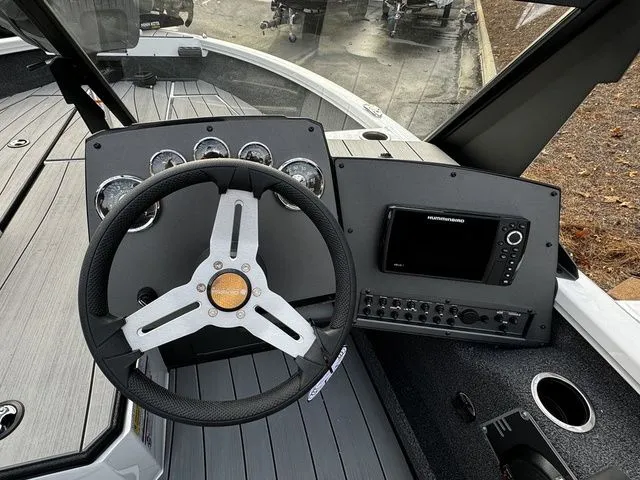 Slide: The Image of 2024 Vexus ADX180 boat dashboard with steering wheel and electronic display. - 6
