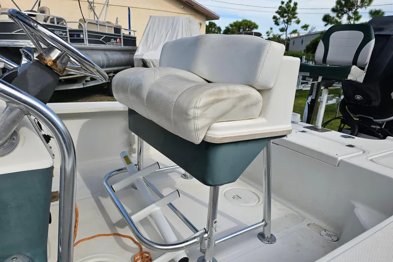 Slide: The Image of 2006 Triton 220 LTS boat interior with steering wheel and cushioned seat. - 16