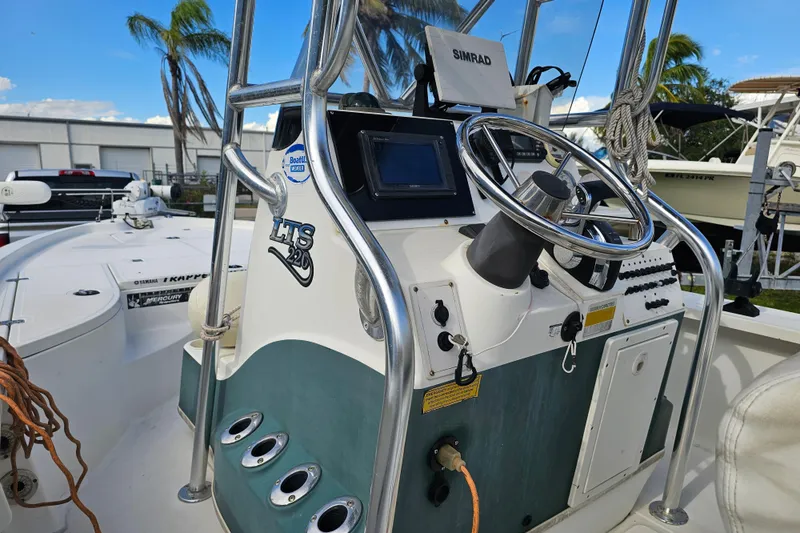Slide: The Image of 2006 Triton 220 LTS boat dashboard with steering wheel and navigation equipment. - 17