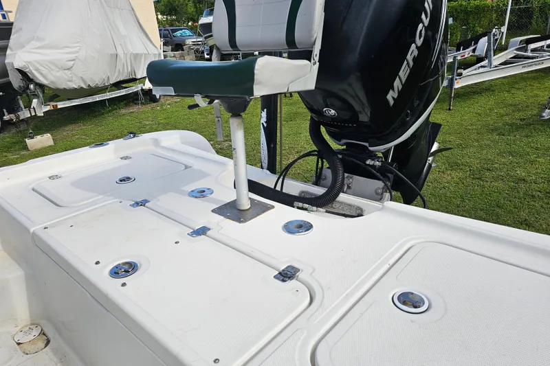 Slide: The Image of 2006 Triton 220 LTS boat with Mercury engine, featuring a white deck and seating. - 19