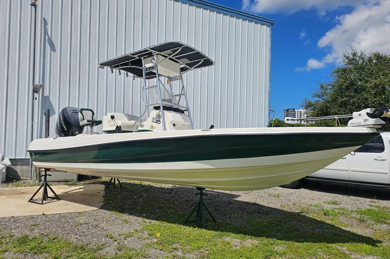 Slide: The Image of 2006 Triton 220 LTS boat on stands, outdoors, with blue sky background. - 20