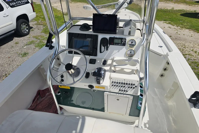 Slide: The Image of 2006 Triton 220 LTS boat dashboard with steering wheel and navigation equipment. - 29