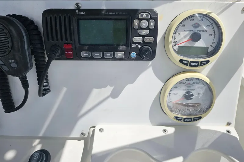Slide: The Image of Control panel of a 2006 Triton 220 LTS boat with gauges and radio. - 40