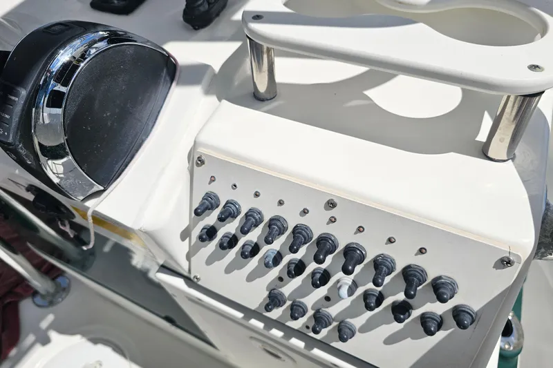 Slide: The Image of Control panel of a 2006 Triton 220 LTS boat with switches and throttle. - 41