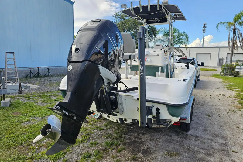 Slide: The Image of 2006 Triton 220 LTS boat with Mercury outboard motor, parked outdoors. - 9
