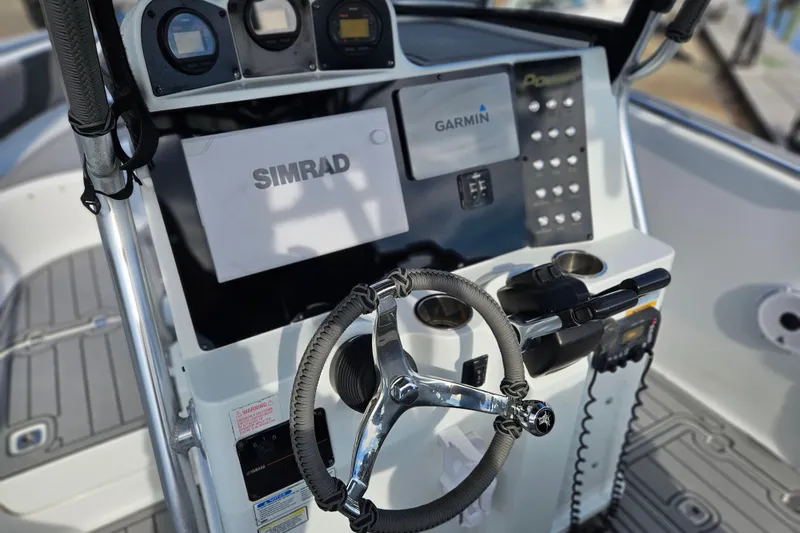 Slide: The Image of 2006 Polar 2700 Center Console boat dashboard with Simrad and Garmin electronics. - 20
