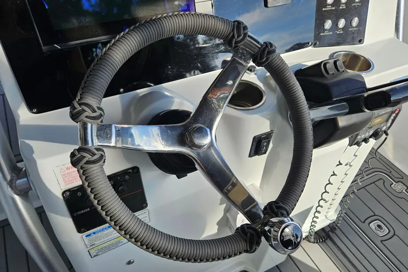 Slide: The Image of Steering wheel of a 2006 Polar 2700 Center Console boat with control panel. - 21