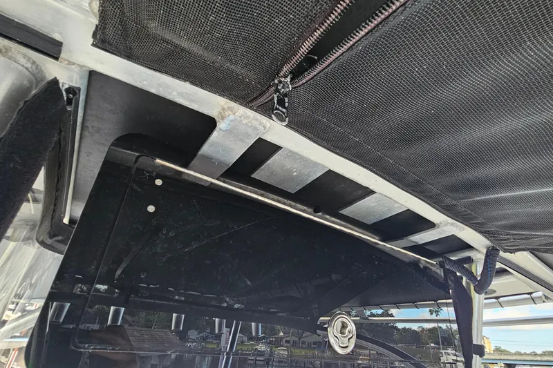 Slide: The Image of 2006 Polar 2700 Center Console boat canopy and storage compartment detail. - 24