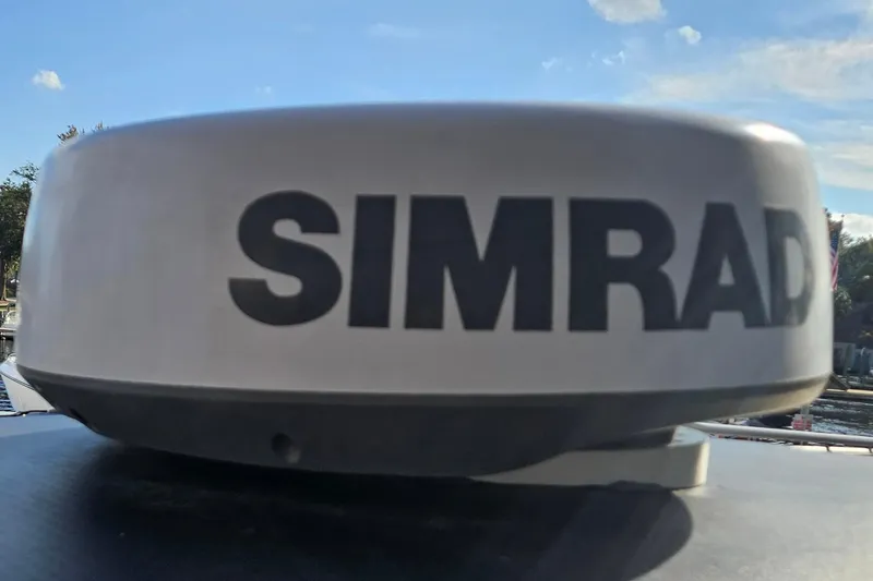 Slide: The Image of Simrad radar on 2006 Polar 2700 Center Console boat under blue sky. - 27