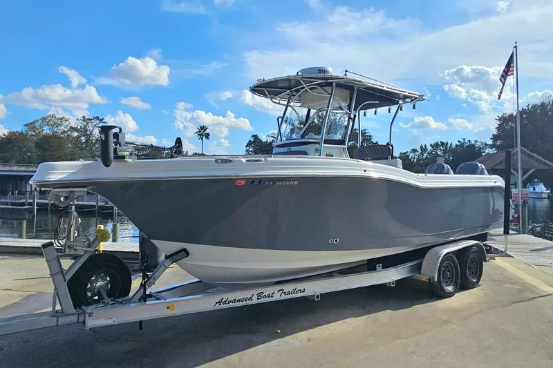 Slide: The Image of 2006 Polar 2700 Center Console boat on trailer at dockside under blue sky. - 3