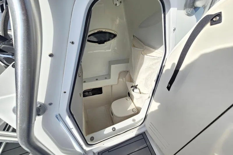Slide: The Image of 2006 Polar 2700 Center Console boat interior with compact marine toilet. - 31