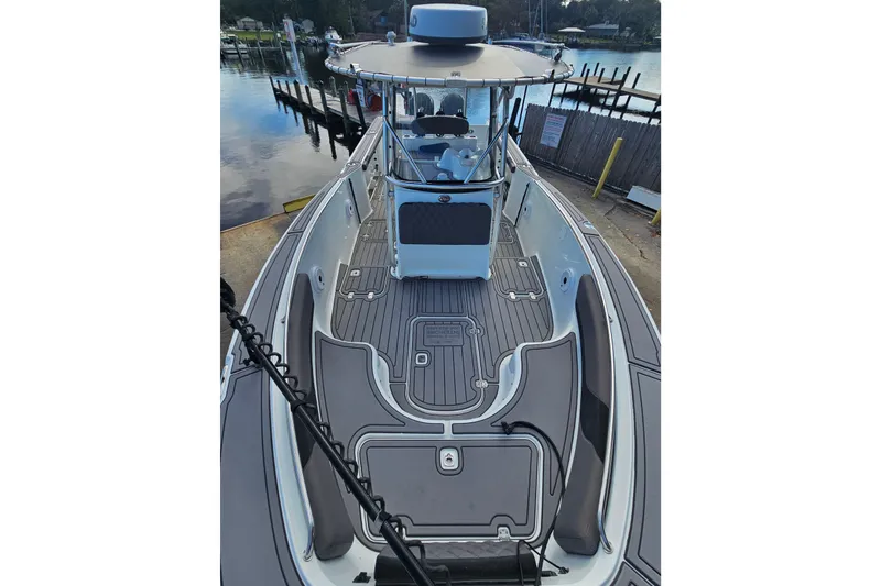 Slide: The Image of 2006 Polar 2700 Center Console boat docked, featuring spacious deck and modern design. - 33