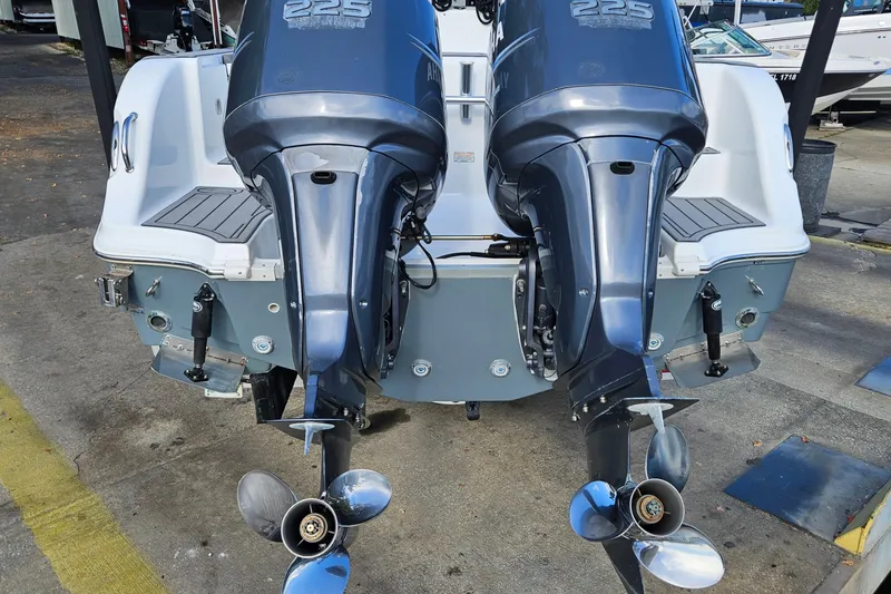 Slide: The Image of 2006 Polar 2700 Center Console with dual outboard engines, docked on concrete. - 35
