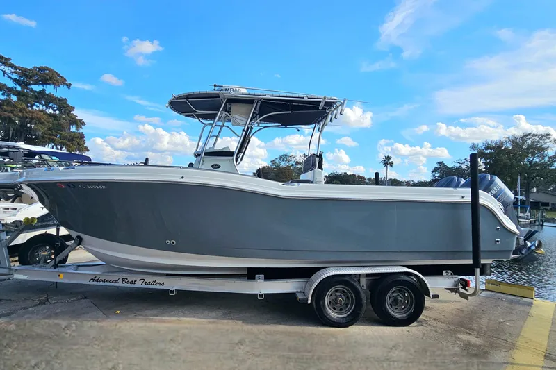 Slide: The Image of 2006 Polar 2700 Center Console boat on trailer by the water. - 4