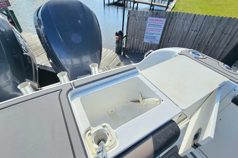 Slide: The Image of 2006 Polar 2700 Center Console boat with dual engines and fishing rod holders. - 9