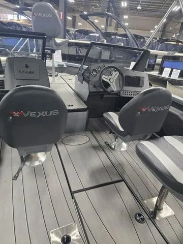 Slide: The Image of 2024 Vexus ADX180 boat interior with steering console and seating. - 4
