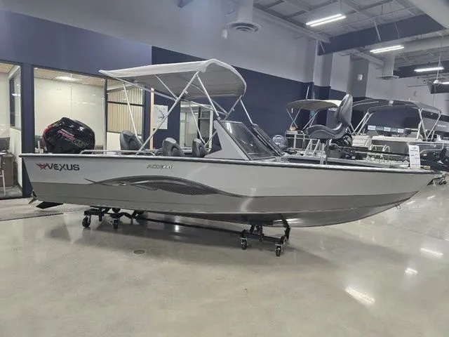 The Image of 2024 Vexus ADX180 boat displayed indoors, featuring sleek design and canopy. - 1