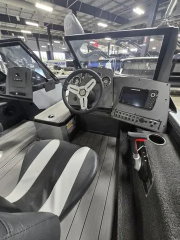 Slide: The Image of 2024 Vexus ADX180 boat interior with steering wheel and navigation system. - 6