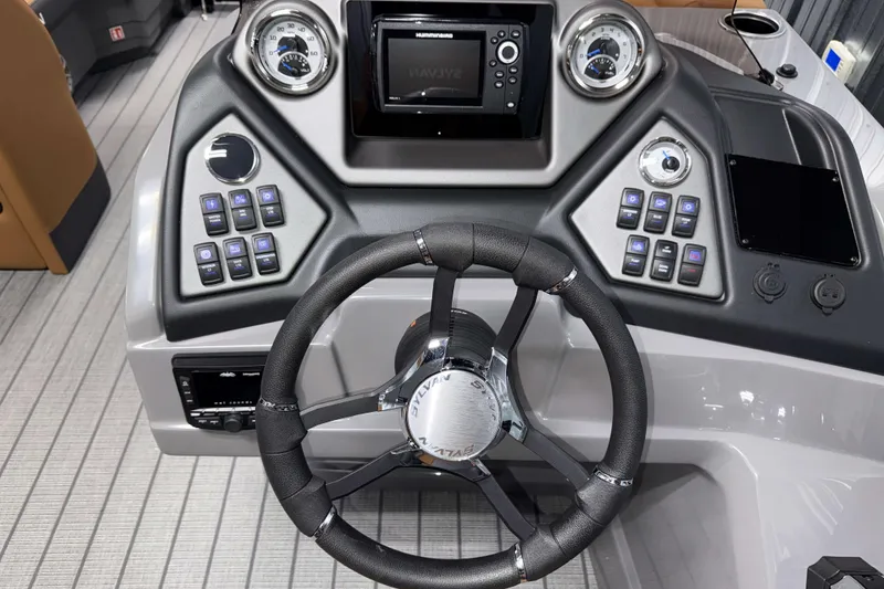 Slide: The Image of Steering console of 2026 Sylvan L3 CLZ DH boat with modern controls and gauges. - 11
