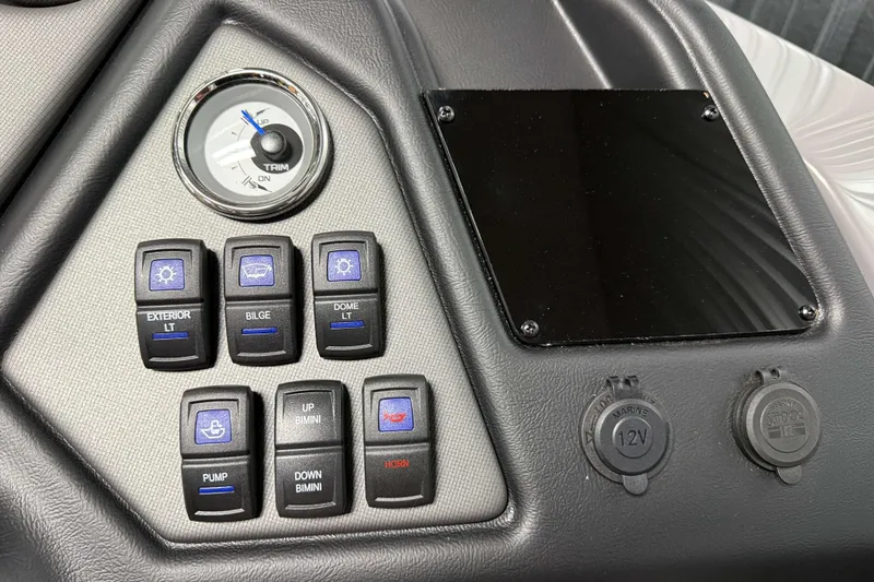 Slide: The Image of Control panel of 2026 Sylvan L3 CLZ DH boat with switches and trim gauge. - 15