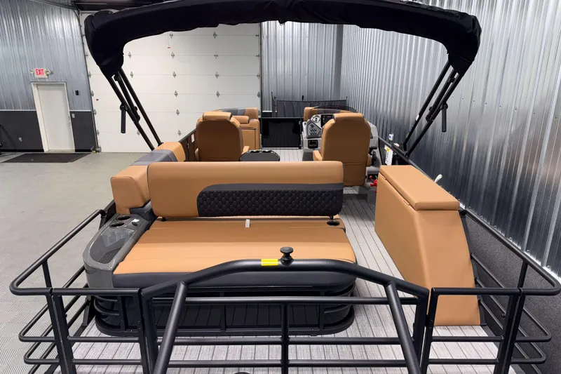 Slide: The Image of 2026 Sylvan L3 CLZ DH pontoon boat interior with tan seating and black canopy. - 20