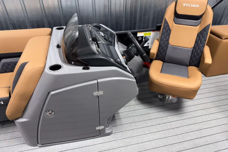 Slide: The Image of 2026 Sylvan L3 CLZ DH boat interior with tan and gray seating and control panel. - 8