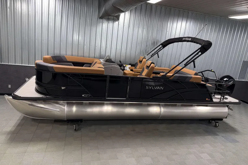 The Image of 2026 Sylvan L3 CLZ DH pontoon boat in showroom, featuring sleek design and tan seating. - 0