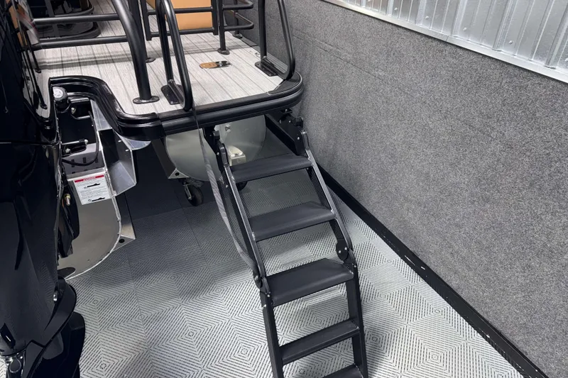 Slide: The Image of 2026 Sylvan L3 CLZ DH boat with black ladder and textured flooring. - 29