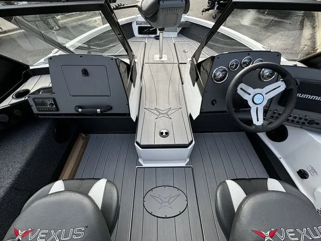 Slide: The Image of 2024 Vexus ADX190 boat interior with steering wheel, dashboard, and seating. - 6
