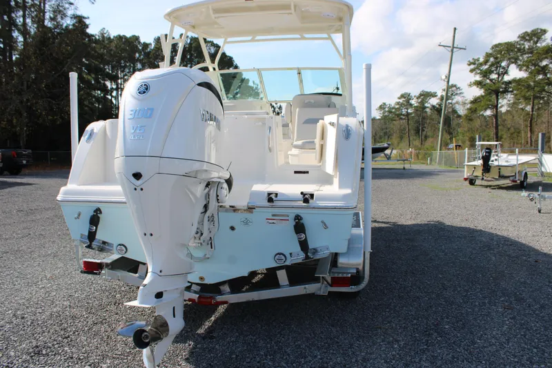 Slide: The Image of 2026 Sailfish 245 DC boat with Yamaha 300 V6 engine, parked on gravel. - 14