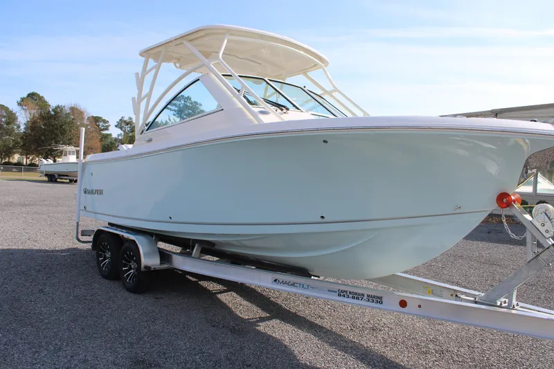 Slide: The Image of 2026 Sailfish 245 DC boat on trailer, parked outdoors. - 17