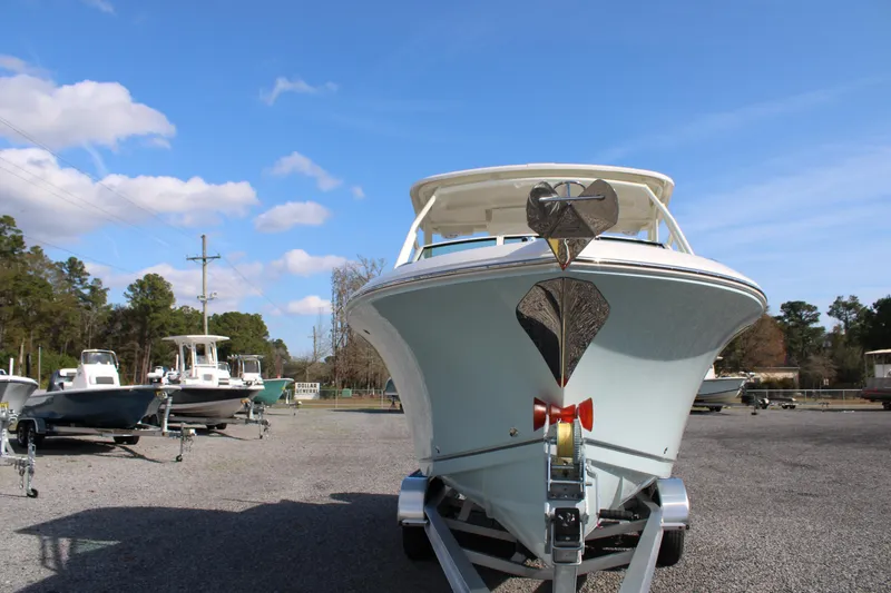 Slide: The Image of 2026 Sailfish 245 DC boat on trailer under clear blue sky. - 18
