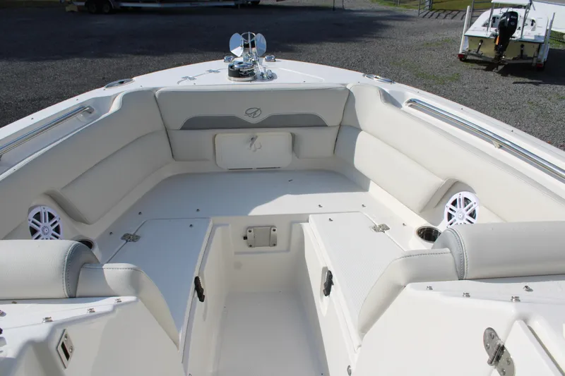 Slide: The Image of 2026 Sailfish 245 DC boat interior with white seating and storage compartments. - 23