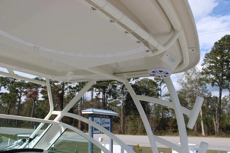 Slide: The Image of 2026 Sailfish 245 DC boat canopy with speaker, set against a wooded background. - 35