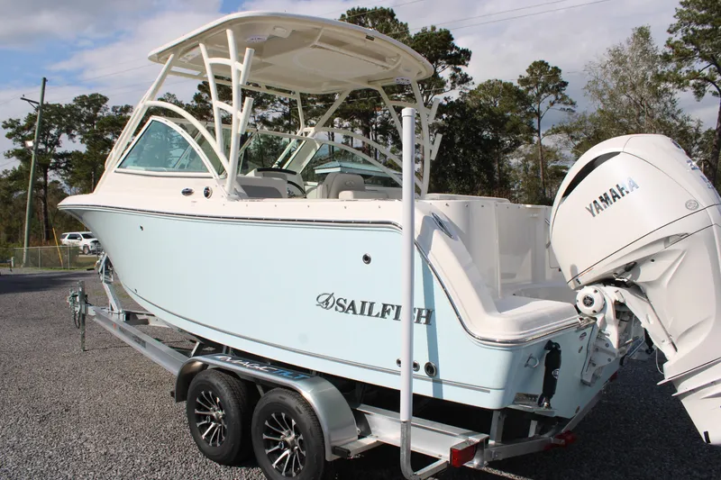 Slide: The Image of 2026 Sailfish 245 DC boat on trailer with Yamaha engine, parked outdoors. - 38