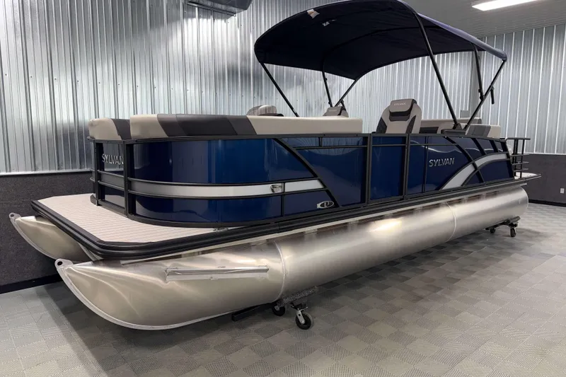 Slide: The Image of 2026 Sylvan L3 CLZ DH pontoon boat with blue exterior and canopy in showroom. - 18