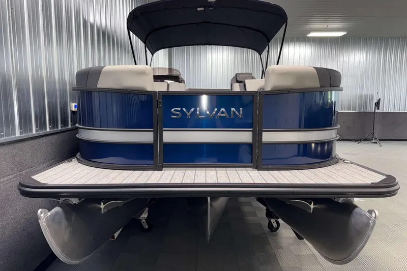 Slide: The Image of 2026 Sylvan L3 CLZ DH pontoon boat in showroom, featuring sleek blue design. - 19