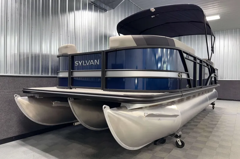 Slide: The Image of 2026 Sylvan L3 CLZ DH pontoon boat in a showroom, featuring sleek design and modern amenities. - 20