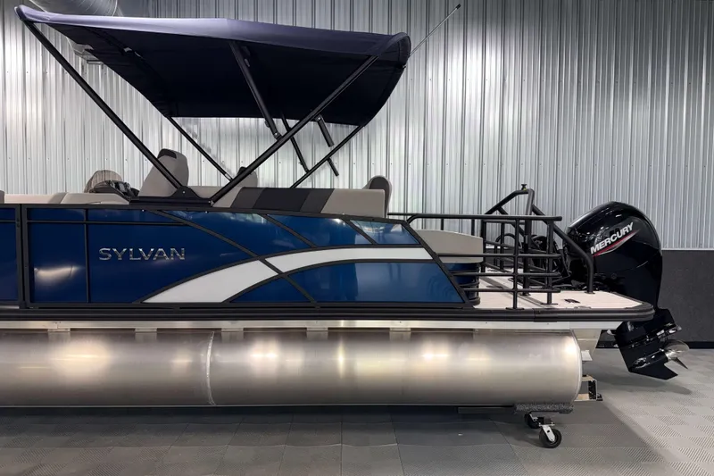 Slide: The Image of 2026 Sylvan L3 CLZ DH pontoon boat with Mercury outboard motor in showroom. - 23