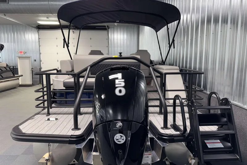Slide: The Image of 2026 Sylvan L3 CLZ DH pontoon boat with 150 horsepower engine in showroom. - 26