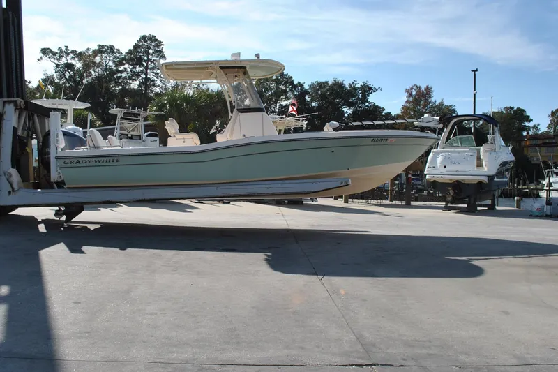 Slide: The Image of 2021 Grady-White 251 Coastal Explorer boat helm against clear blue sky. - 22