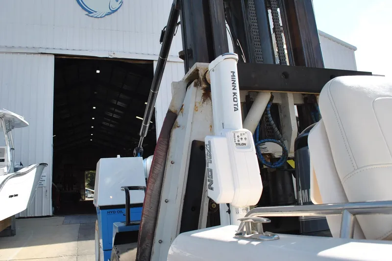 Slide: The Image of 2021 Grady-White 251 Coastal Explorer boat interior at marina, featuring cushioned seating. - 26