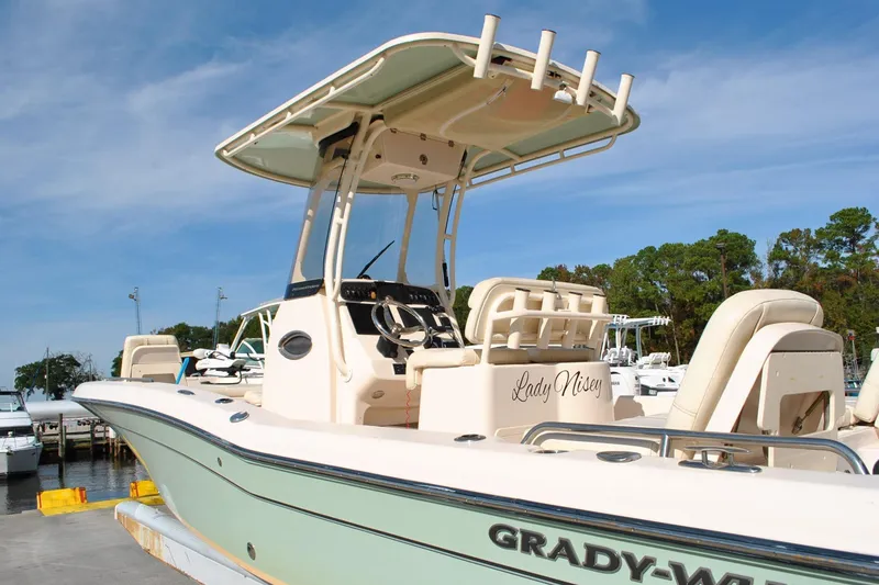 Slide: The Image of Garmin marine equipment on 2021 Grady-White 251 Coastal Explorer boat, docked by water. - 27