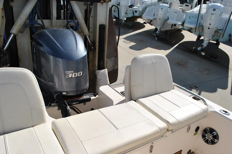 Slide: The Image of 2021 Grady-White 251 Coastal Explorer boat interior with cushioned seating and cup holders. - 33