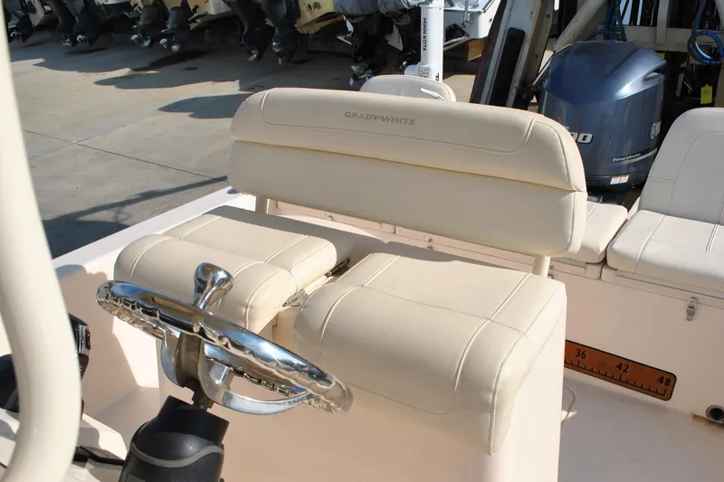 Slide: The Image of 2021 Grady-White 251 Coastal Explorer boat dashboard with navigation controls and instruments. - 37